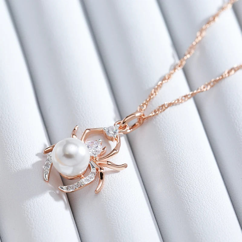 Close-up of the Pearl Weaver pendant showing cubic zirconia stones and a round pearl-style centrepiece