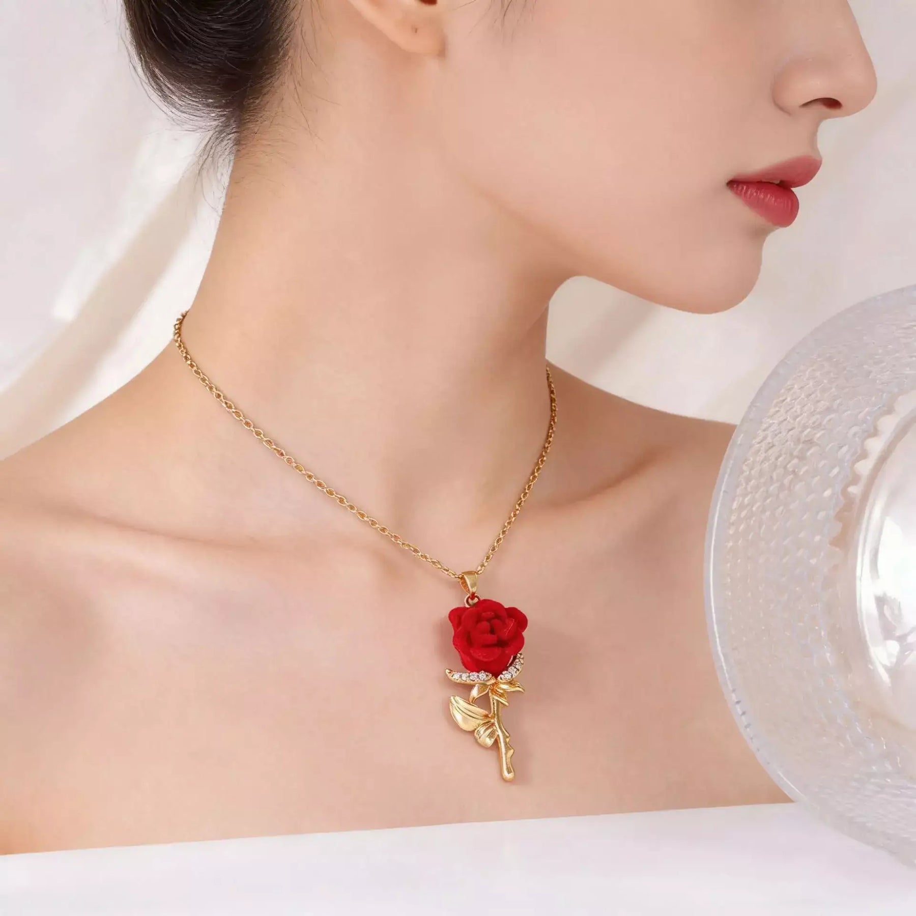 Woman wearing the Rose Necklace of Love with elegant red rose pendant