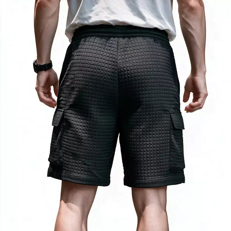 Back view of man wearing black waffle cargo shorts