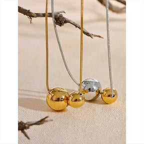 women’s necklace, sphere necklace, gold-plated necklace, elegant jewellery, modern necklace, sophisticated accessory, water-resistant necklace, gift for her, unisex necklace, minimalist necklace, stainless steel necklace, everyday necklace