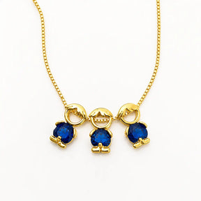 Gold-tone necklace with three boy figure pendants and blue stones